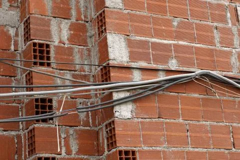 Brick skeleton of building under construction with electrical wiring Stock Photos