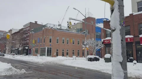 Brick Storefronts on Snow-Covered Brooklyn Commercial Street, Blizzard Video stock 329888783