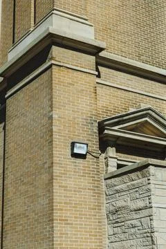 Brick structure and light fixture on the corner of a building under a clear.. Fotos Stock