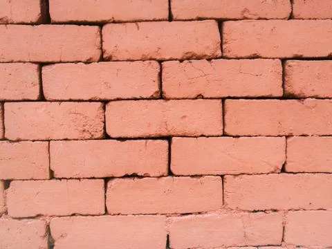 A Brick texture made on a wall using natural bricks of red color. Stock Photos