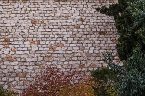Brick texture old vintage background. Dirty aged and rust stone surface facade. Stock Photos
