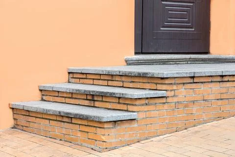 Brick threshold with granite steps to the front door. Stock Photos