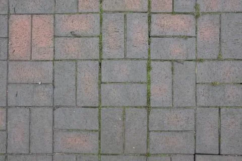 A brick walkway with a pattern of squares and rectangles Stock Photos