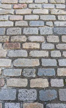A brick walkway with a stone surface Stock Photos
