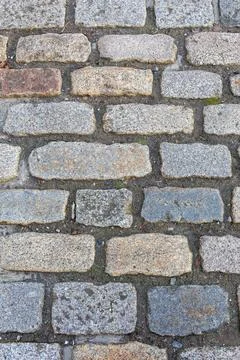 A brick walkway with a stone surface Stock Photos