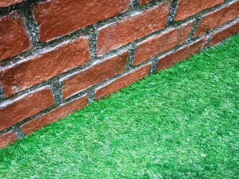 Brick wall and Artificial Grass Foto stock