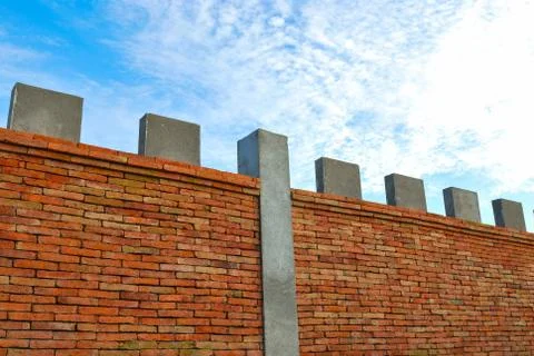 Brick wall and blue sky Stock Photos