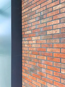 Brick wall and metal panel provide contrast in urban setting at daytime in ci Stock Photos