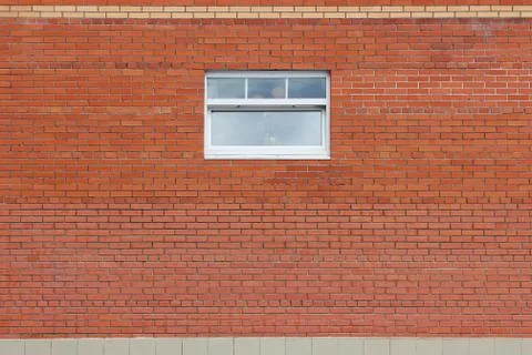 Brick wall and one window in a background image Stock Photos