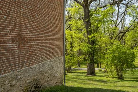 Brick wall and park in springtime scenery - historic town of Arrow Rock, Mi.. Stock Photos
