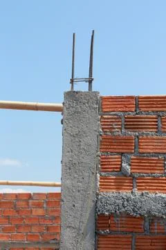 Brick wall and pole house in residential building construction site 写真素材