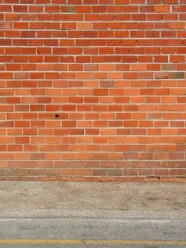 Brick wall and sidewalk Stock-Fotos