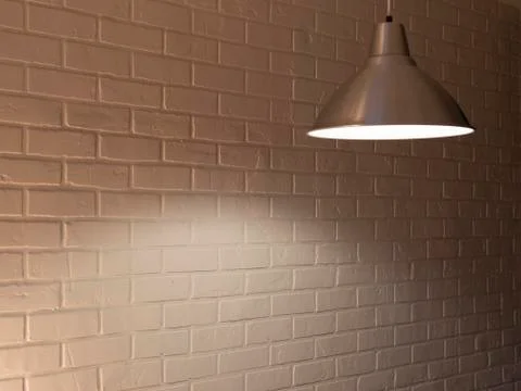 Brick wall and three ceiling lamp. warm light yellow Stock Photos