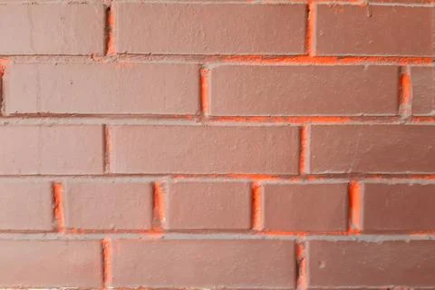 Brick wall background. Bright brown-orange. Stock Photos