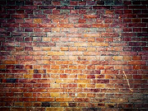 Brick wall background. Brown and red bricks, masonry texture of a building... Fotos de archivo