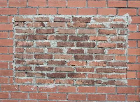 Brick wall background in the form Stock Photos