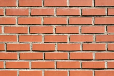 Brick wall background, texture of red stone blocks closeup Stock Photos