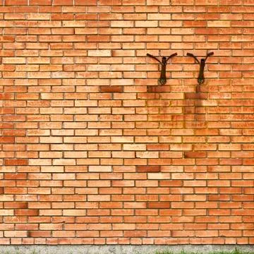 Brick wall background, two flag holders Stock Photos