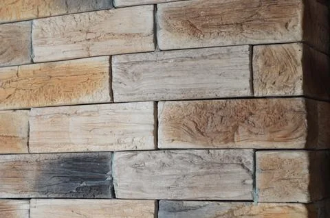 A brick wall with a beautiful texture of brown wooden boards, an element of.. Foto stock