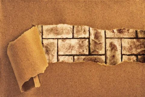 Brick wall behind torn recycled paper Stock Photos