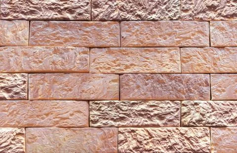 Brick wall of beige bricks. Background and texture of brickwork. Stock Photos