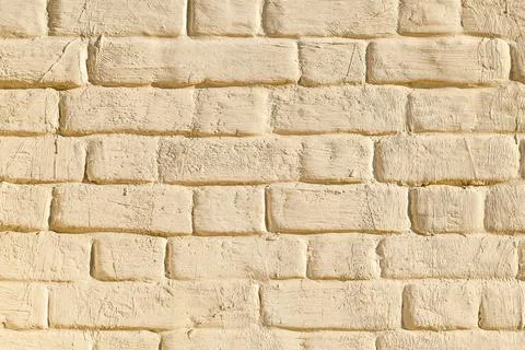 Brick wall with biege plaster texture background Stock Photos