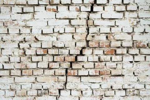 Brick wall with a big crack in the middle Stock Photos