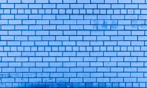 Brick wall with blue masonry, uniform pattern, textured surface. Stock Photos