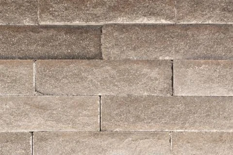 Brick wall of brown brick. Creative vintage background. Stock Photos