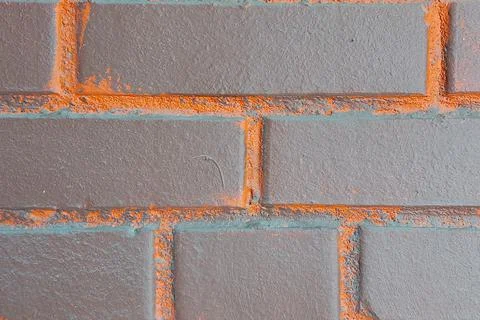 Brick wall. Brown with orange inserts. Stock Photos
