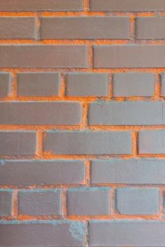 Brick wall. Brown with orange inserts. Stock Photos