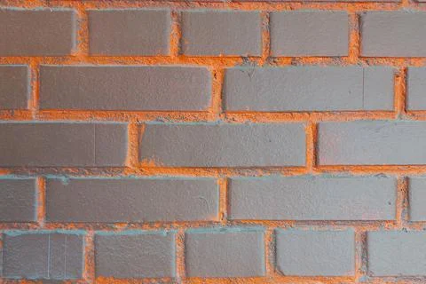 Brick wall. Brown with orange inserts. Stock Photos