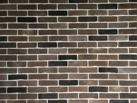 Brick wall in brown tones of different colors. Background for design Stock Photos