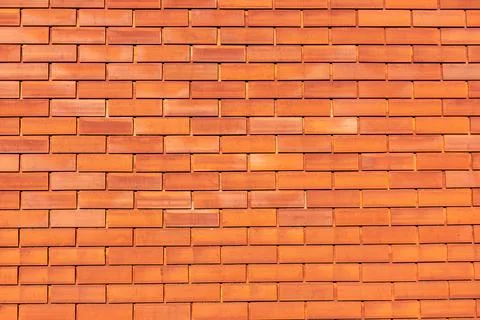 The brick wall is built of red brick in a beautiful color Stock Photos