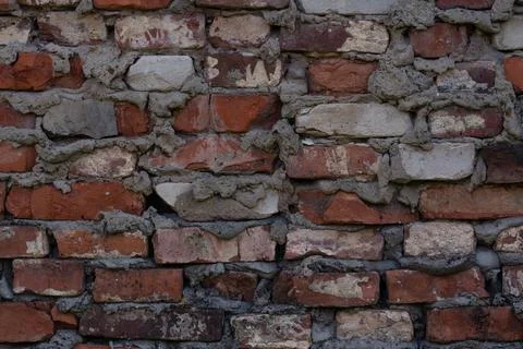 The brick wall of the castle is damaged. Brick wall background. Brick backg.. Stock Photos