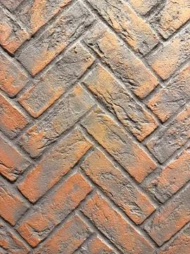 A brick wall with a chevron pattern Foto stock