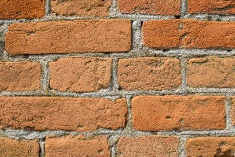 Brick wall close-up. Brick laying on cement mortar. Stock Photos