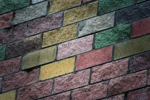 A brick wall with a colorful pattern Stock Photos