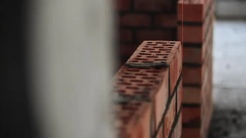 Brick wall construction with masonry alignment string Stock Footage 323869984