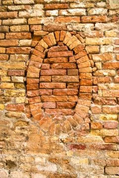 Brick wall with a covered window Stock Photos