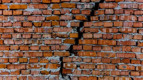 Brick wall with crack, wall background, texture. The concept of the old house Stock Photos