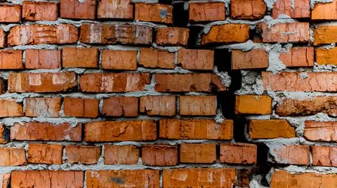 Brick wall with crack, wall background, texture. The concept of the old house Stock Photos