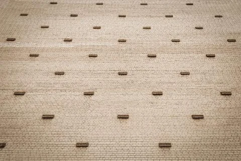 Brick wall with dark ledges. Perspective lines. Use as a background. Stock Photos