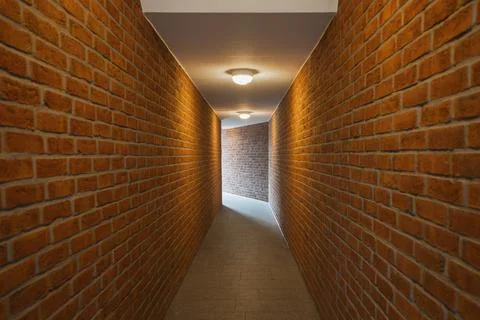 Brick wall of an empty corridor Stock Photos