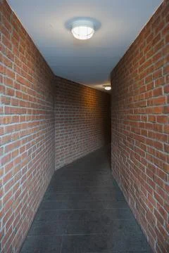 Brick wall of an empty corridor Stock Photos