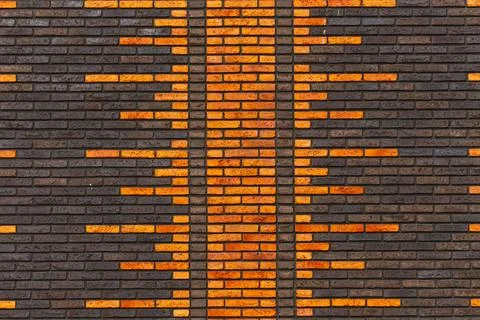 Brick wall facade with orange geometric soundwave pattern Stock Photos