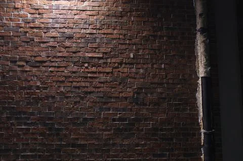 Brick wall facade under flood light at night Stock Photos