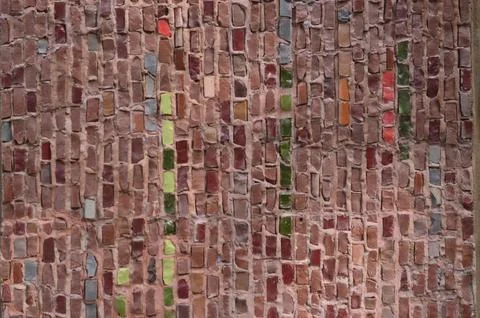 A brick wall with a green and red stripe. Stock Photos