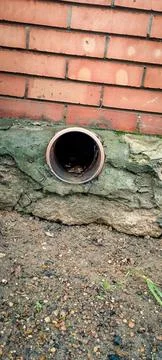 A brick wall with a hole in it.  Stock Photos