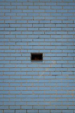 A brick wall with a hole in it Stock Photos